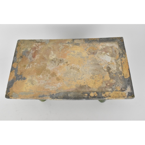 88 - A Chinese Ming dynasty glazed pottery model tomb table and food, the table with a rectangular top an... 