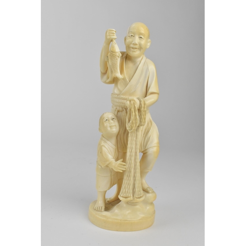 98 - A Japanese Meiji period ivory Okimono of a fisherman holding two fish and a net with a boy by his si... 