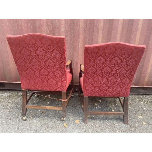 151 - A pair of George III mahogany open arm chairs with an arched upholstered back, shaped arms, and upho... 