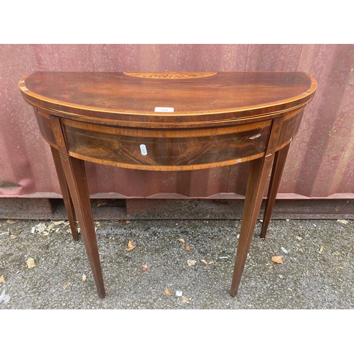 152 - A George III mahogany and marquetry card table, with a foldover top, over a crossbanded frieze, rais... 