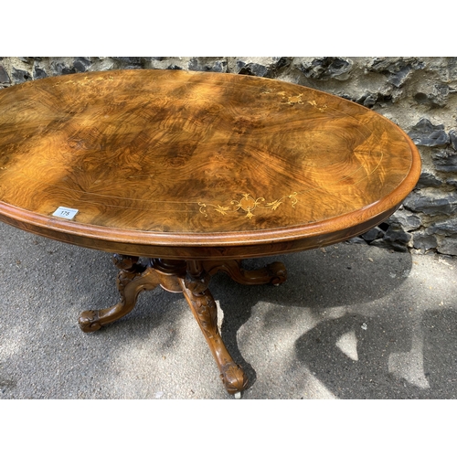 175 - A mid Victorian walnut and marquetry loo table, over turned, fluted columns, on carved splayed legs ... 