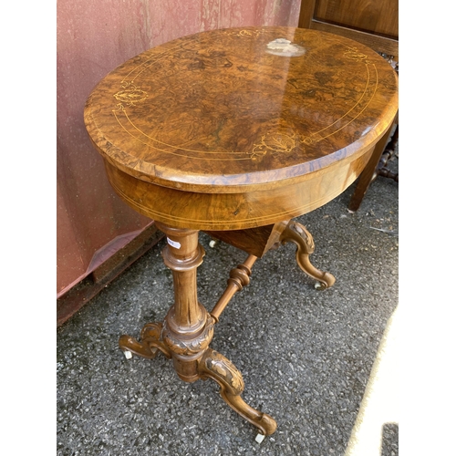 176 - A late Victorian figured walnut and marquetry oval work table, with a hinged lid, enclosing a compar... 