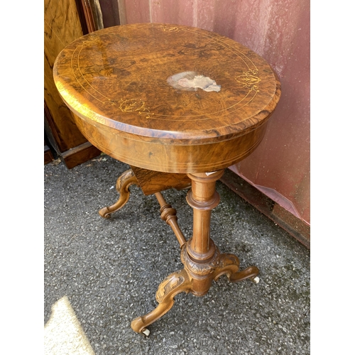 176 - A late Victorian figured walnut and marquetry oval work table, with a hinged lid, enclosing a compar... 