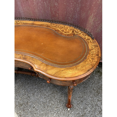 177 - A late Victorian figured walnut and marquetry kidney shaped desk, with a gilt metal gallery and brow... 