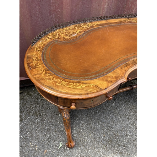 177 - A late Victorian figured walnut and marquetry kidney shaped desk, with a gilt metal gallery and brow... 