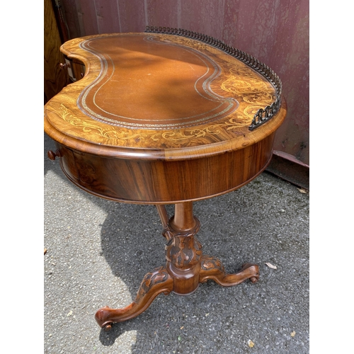 177 - A late Victorian figured walnut and marquetry kidney shaped desk, with a gilt metal gallery and brow... 