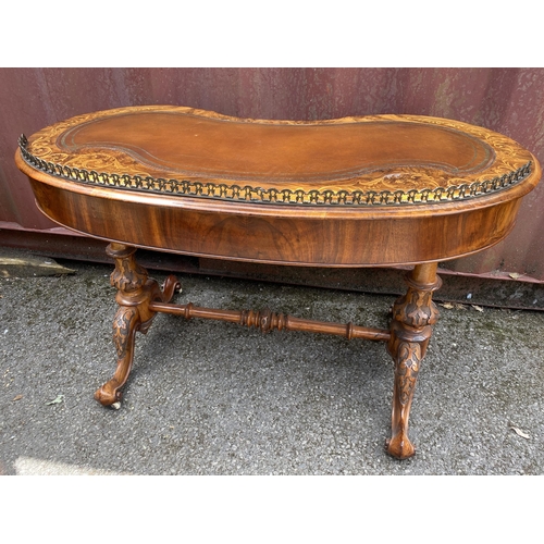 177 - A late Victorian figured walnut and marquetry kidney shaped desk, with a gilt metal gallery and brow... 