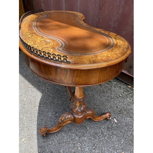 177 - A late Victorian figured walnut and marquetry kidney shaped desk, with a gilt metal gallery and brow... 