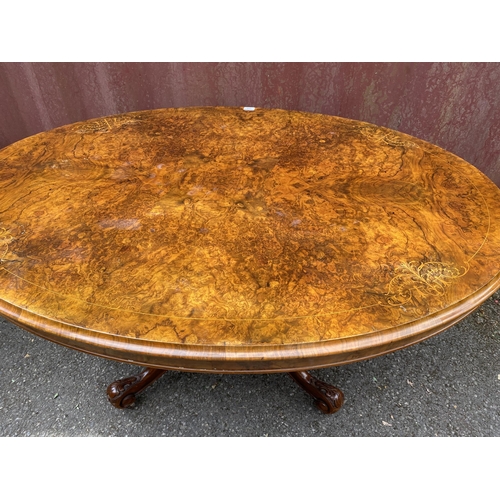 178 - A late Victorian figured walnut and marquetry loo table with an oval tip top, over a bulbous carved ... 