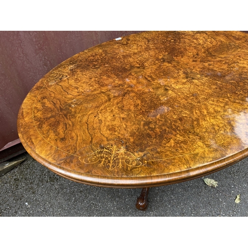 178 - A late Victorian figured walnut and marquetry loo table with an oval tip top, over a bulbous carved ... 