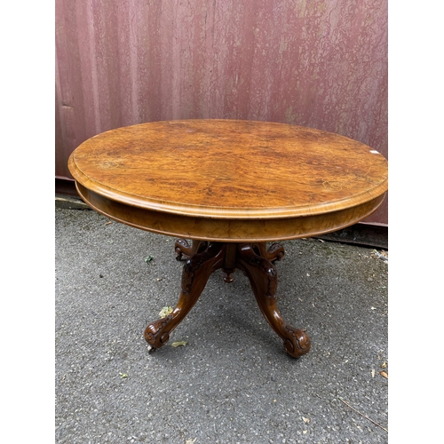 178 - A late Victorian figured walnut and marquetry loo table with an oval tip top, over a bulbous carved ... 