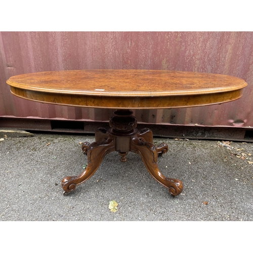 178 - A late Victorian figured walnut and marquetry loo table with an oval tip top, over a bulbous carved ... 