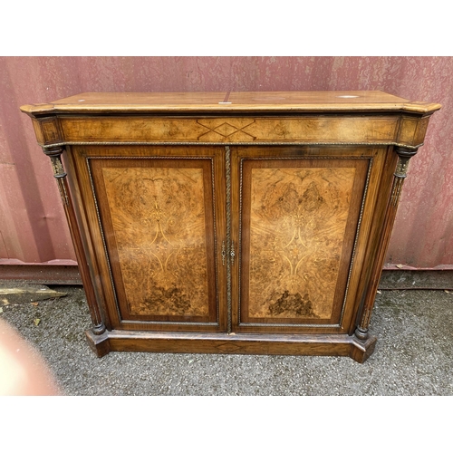 180 - A late Victorian mixed veneer and marquetry cabinet with gilt metal mounts, a pair of panelled doors... 