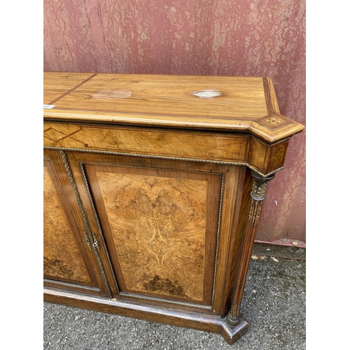 180 - A late Victorian mixed veneer and marquetry cabinet with gilt metal mounts, a pair of panelled doors... 