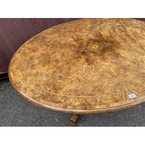 183 - A late Victorian figured walnut and marquetry loo table with an oval tip top, over four columns, on ... 