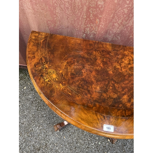 185 - A late Victorian figured walnut and marquetry demi-lune card table, over turned columns, on splayed ... 