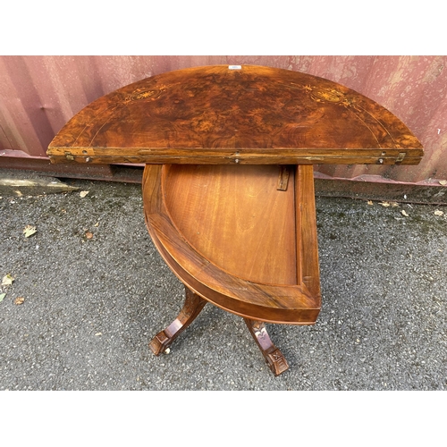 185 - A late Victorian figured walnut and marquetry demi-lune card table, over turned columns, on splayed ... 