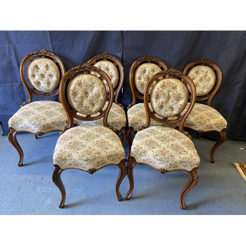 189 - A set of six late Victorian walnut salon chairs, with carved ornament, a button upholstered oval bac... 