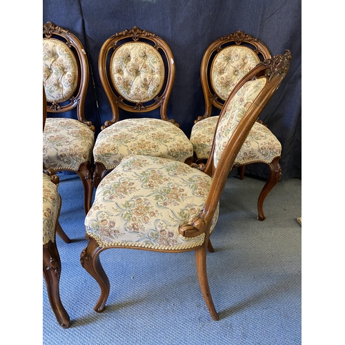 189 - A set of six late Victorian walnut salon chairs, with carved ornament, a button upholstered oval bac... 