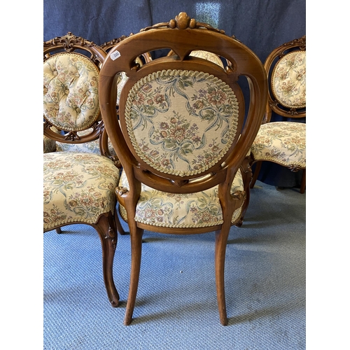 189 - A set of six late Victorian walnut salon chairs, with carved ornament, a button upholstered oval bac... 