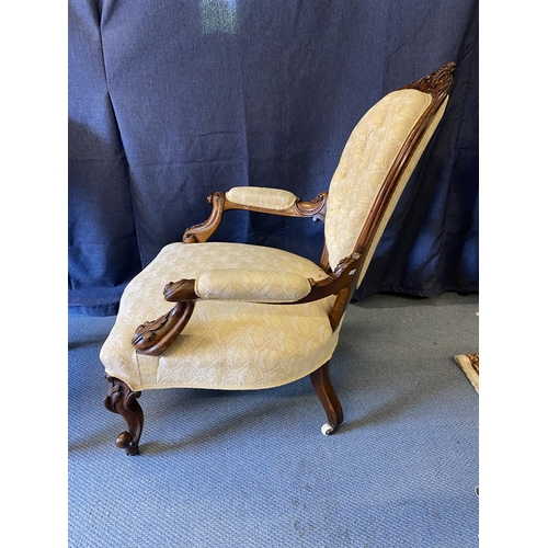 191 - A pair of mid Victorian walnut framed ladies and gentleman's chairs, each with carved crests, oval b... 