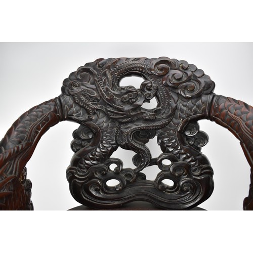 113A - A Chinese late 19th century carved wooden chair with a central panel of a dragon and clouds, the arm... 