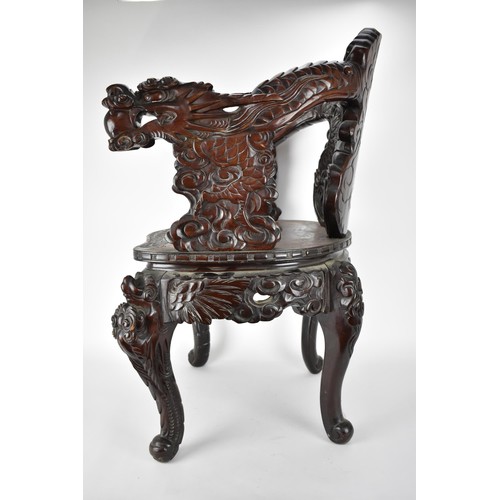 113A - A Chinese late 19th century carved wooden chair with a central panel of a dragon and clouds, the arm... 