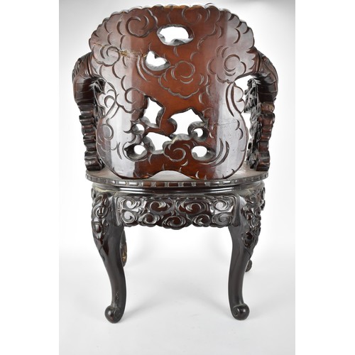 113A - A Chinese late 19th century carved wooden chair with a central panel of a dragon and clouds, the arm... 