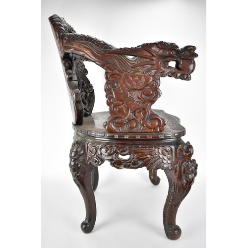 113A - A Chinese late 19th century carved wooden chair with a central panel of a dragon and clouds, the arm... 