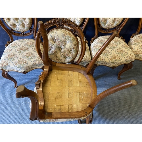 189 - A set of six late Victorian walnut salon chairs, with carved ornament, a button upholstered oval bac... 