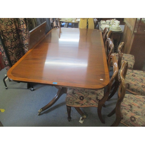 113 - A Regency style mahogany dining table having string inlay and having twin supports, 74cm h, 243.5 w,... 