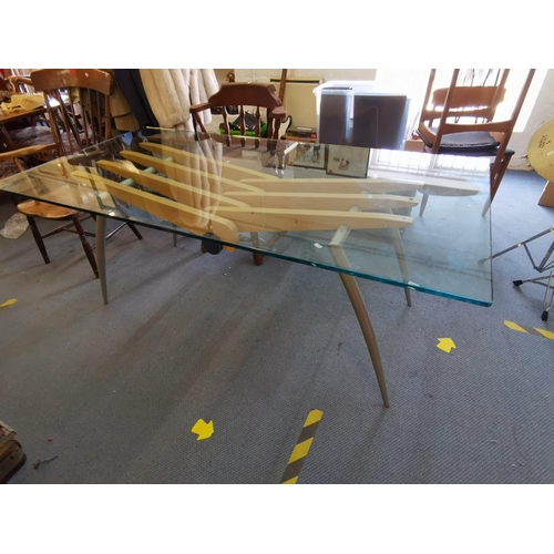 94 - A Frag Italian designer glass top dining table, raised on steel legs joined by Beech supports and le... 