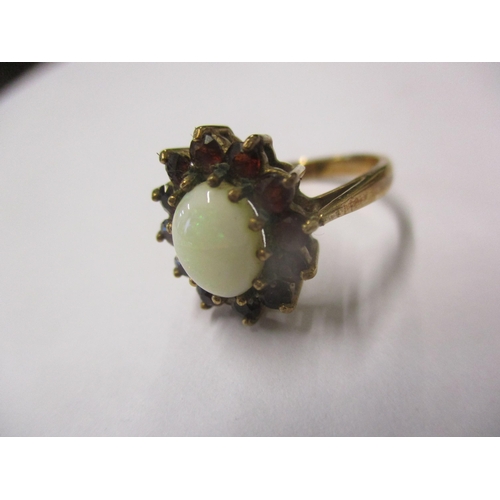 134 - A 9ct gold opal and garnet ring size J, total weight 2.9g Location: Cab