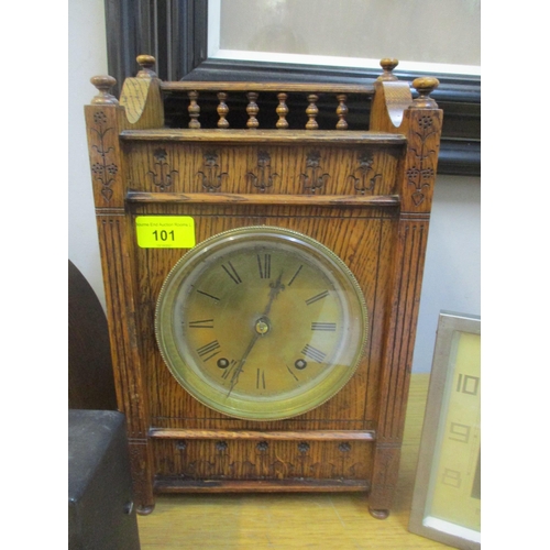 101 - An oak cased mantel clock with galleried top, brass Roman dial, movement striking on a gong with key... 