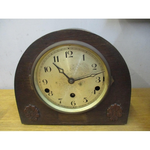 101 - An oak cased mantel clock with galleried top, brass Roman dial, movement striking on a gong with key... 