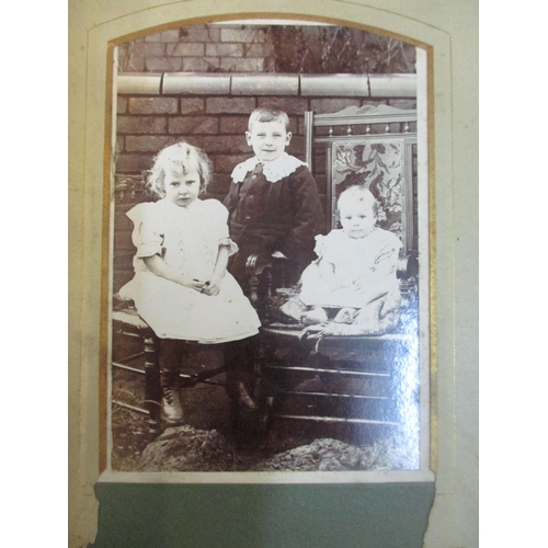 102 - A Victorian leather bound family photograph album with various portrait photographs, a Victorian fam... 