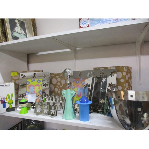 127 - Alessi goods, new in original packaging comprising photo frames, a toast rack, cork screws and other... 