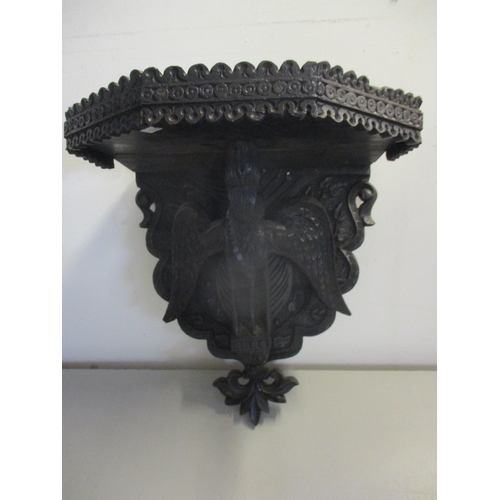 139 - A Black Forest style wooden wall bracket, the support below in the form of a carved mystical bird
Lo... 