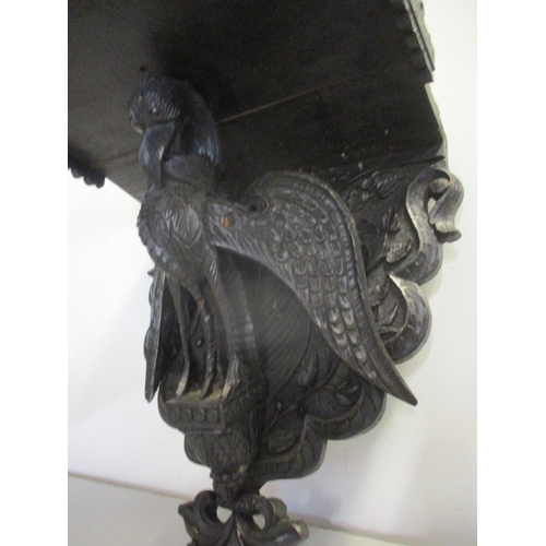 139 - A Black Forest style wooden wall bracket, the support below in the form of a carved mystical bird
Lo... 
