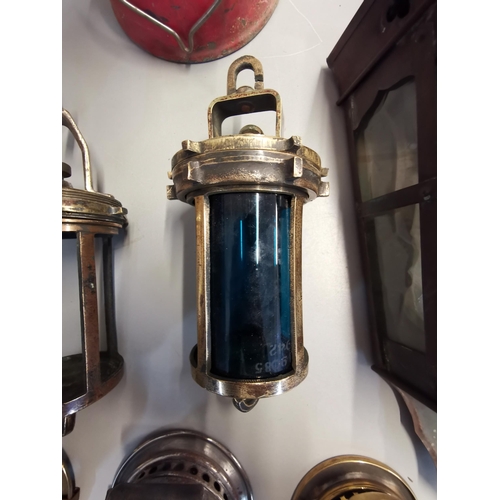 146 - Vintage lighting to include a brass ships lamp marked S and A A P16042, Wolf safety lamp, Powell and... 
