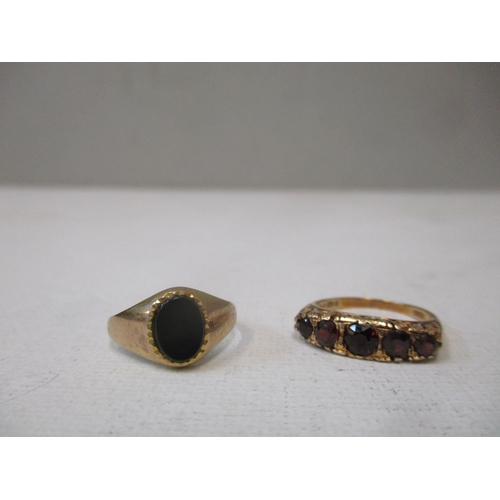 158 - A 9ct gold ring set with five graduated garnets, circa 1970, and a 9ct gold and black onyx plaque ri... 