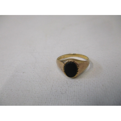 158 - A 9ct gold ring set with five graduated garnets, circa 1970, and a 9ct gold and black onyx plaque ri... 