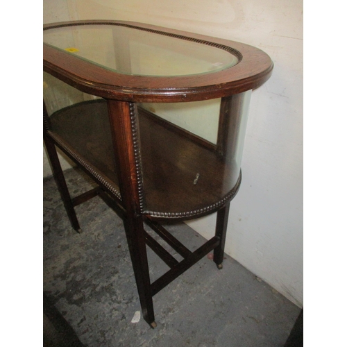166 - A 1930s oak display table with a glazed top, over curved ends and square tapering legs united by str... 