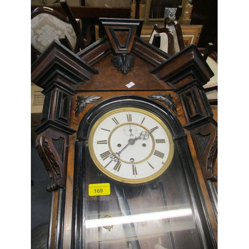 169 - A walnut and ebonized cased Vienna style regulator wall clock with step and leaf carved decoration, ... 
