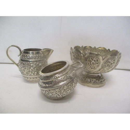 220 - Indian silver with embossed and chased ornament comprising a bowl, a salt and a jug, 306.2g
Location... 