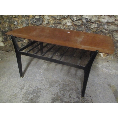 36 - A 1970's retro Nathan teak topped coffee table having ebonised legs and railed magazine tier, 43.5cm... 