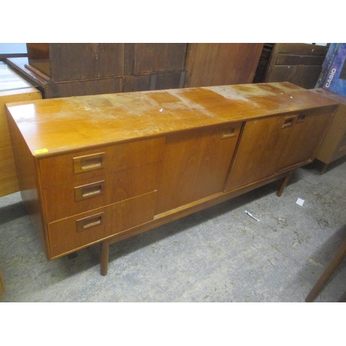 42 - A mid 20th century retro teak sideboard having three drawers, one pull-down door and two sliding doo... 