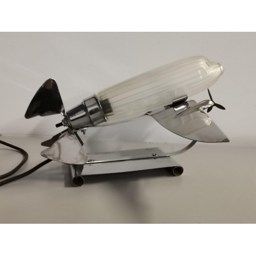77 - A 1970's Art Deco style chrome frosted glass lamp in the form of an early air liner, signed Sarsapar... 