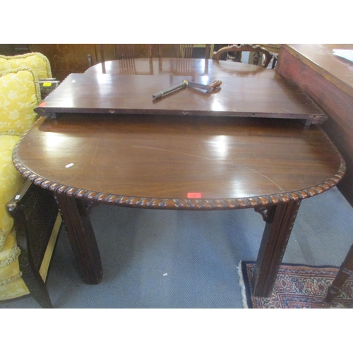 144 - An Edwardian mahogany extending dining table with one extra leaf, having gadrooned edge, pierced sup... 