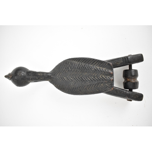 66 - A 19th/20th century Senufo wooden weaving heddle pulley, Ivory Coast, carved as a hornbill bird, a b... 